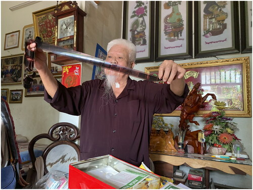 Mr. Lương Khánh Học exhibits a well-preserved roll of negatives that he carefully washed after receiving them from the developer. (Photo by Laurel Kendall)